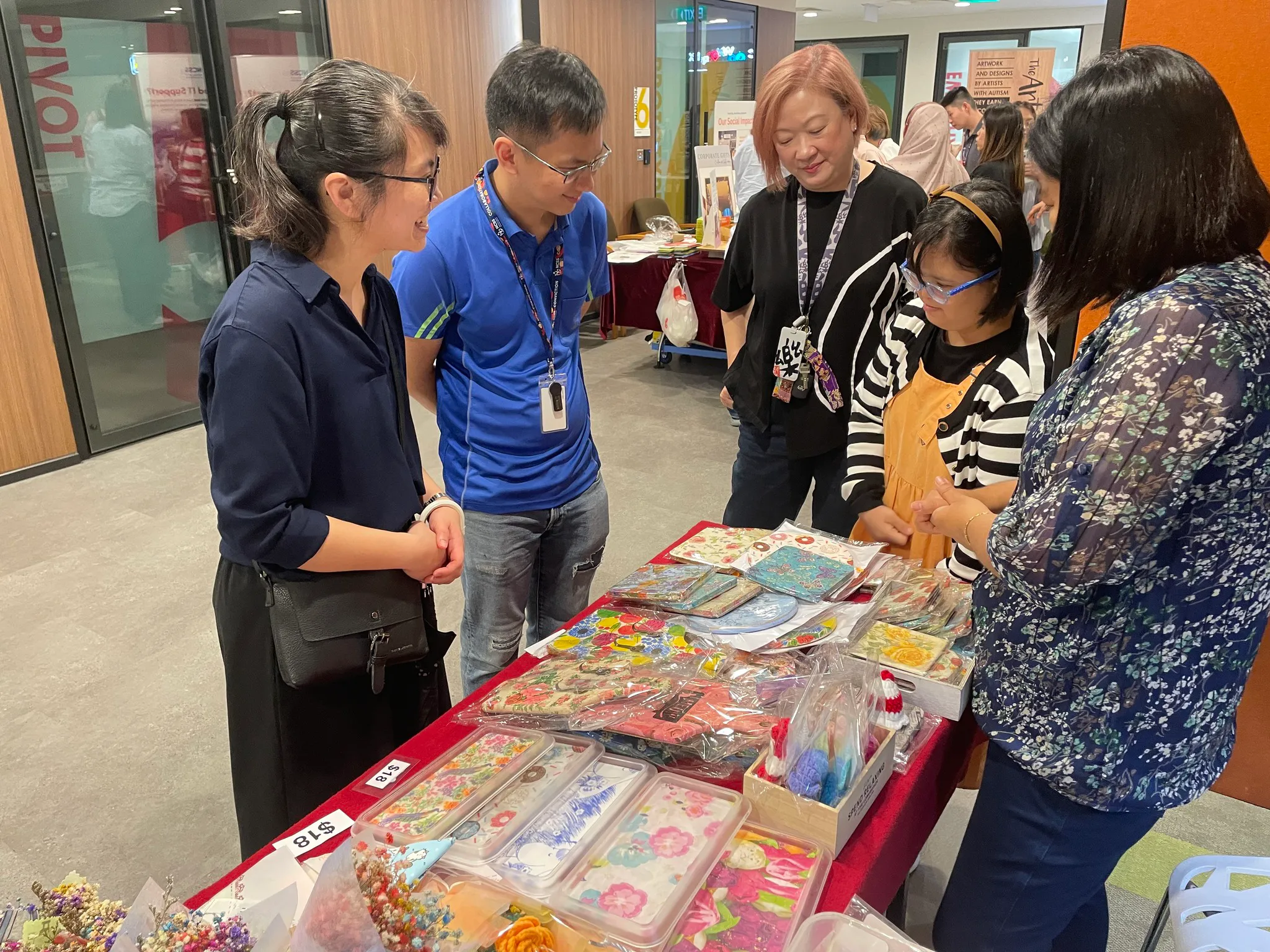 People supporting a booth by a social service enterprise